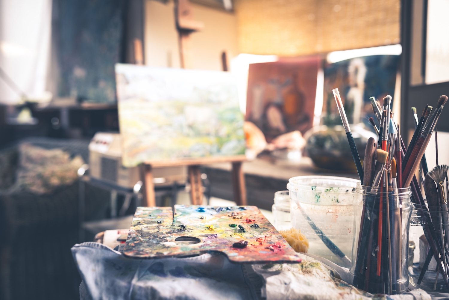 Image of Painting Palette with Brushes in Artist's Studio -- Photo by Getty Images | Article: 8 Beginner Painting Mistakes and How to Conquer Them | Artists Network