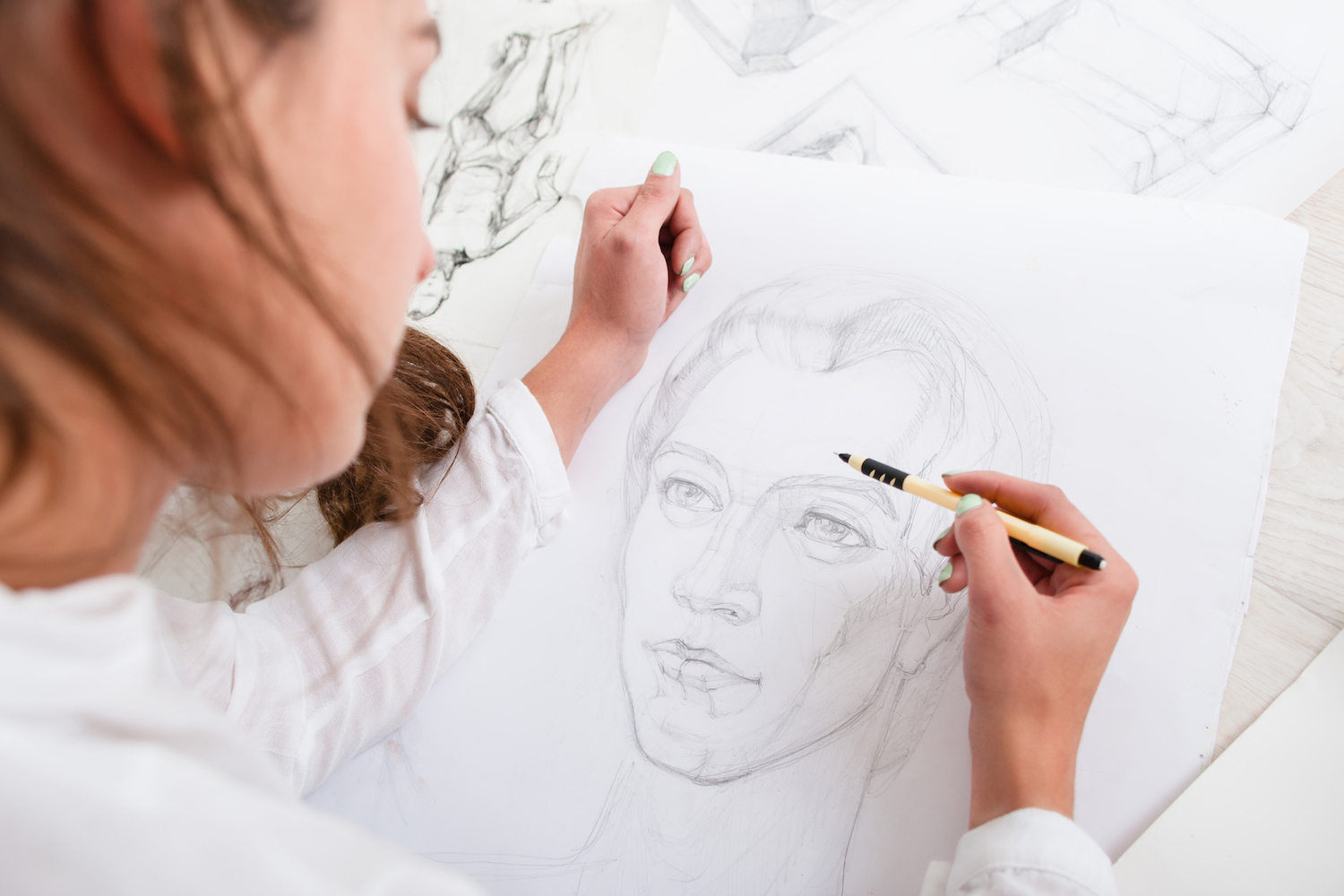 New drawing habits and 10 basics of drawing for beginner artists | Artist drawing a portrait, photo courtesy of Getty Images | Article brought to you by Artists Network